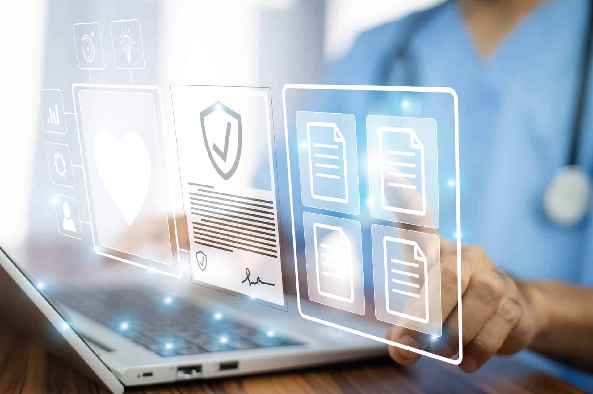 A person in scrubs uses a laptop with digital icons floating above, including a heart, a security badge, and documents, symbolizing digital healthcare management and security.